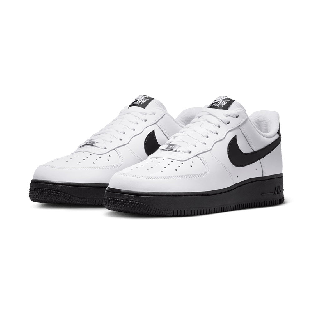 Pair of white low-top sneakers with black swoosh and black rubber sole; lace-up.