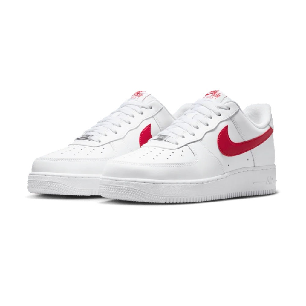 Pair of Nike Air Force 1 low-top sneakers, white leather with red swooshes and laces.