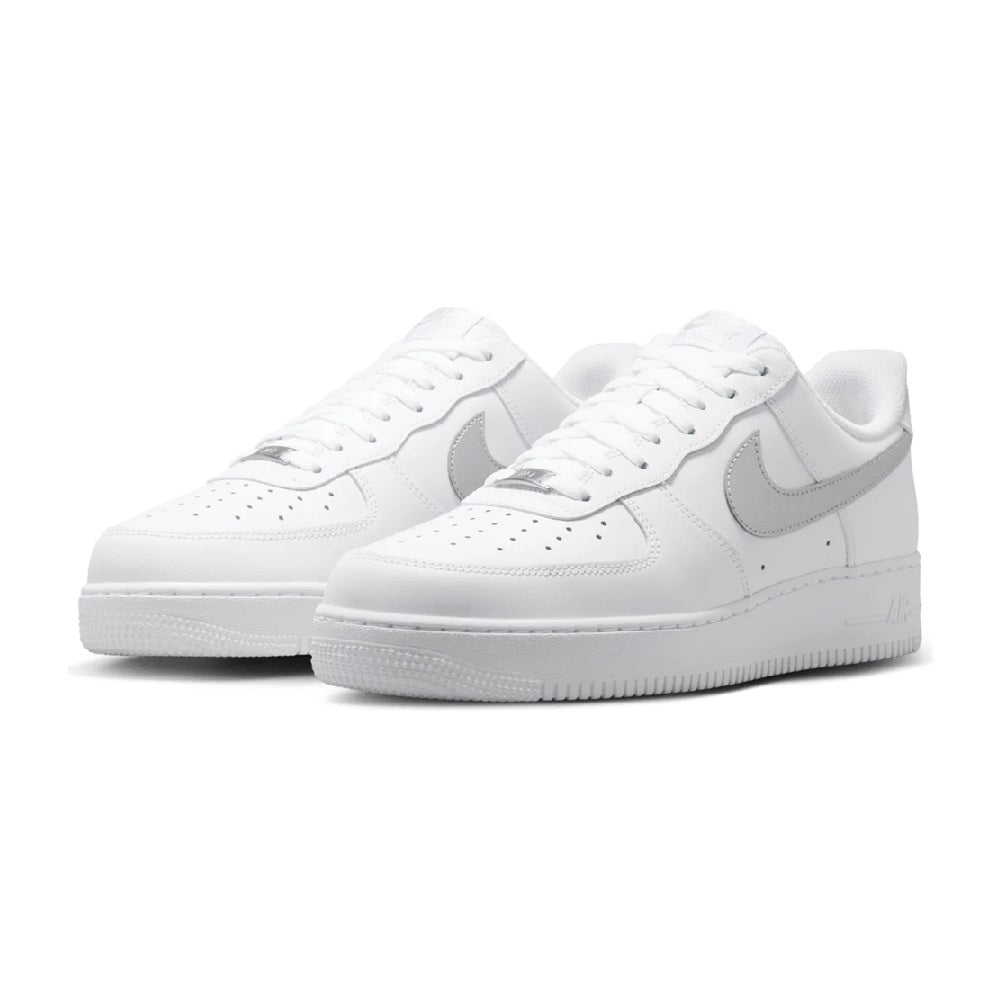 Pair of white Nike Air Force 1 '07 sneakers with silver Swoosh and lace-up design