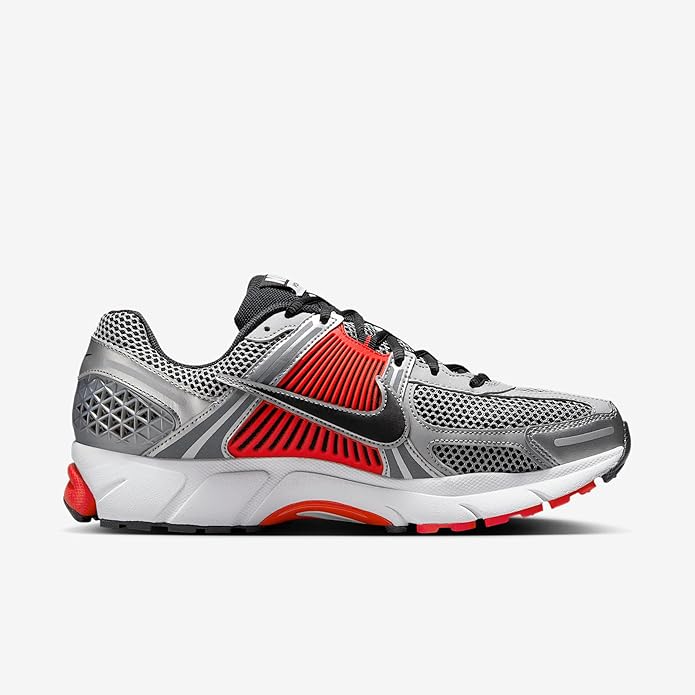 Nike Zoom Vomero 5 running shoe, side view, silver mesh upper with orange-red stripes
