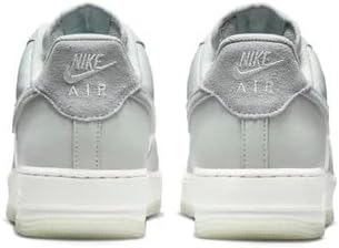 Nike Air Force 1 sneakers with 'AIR' heel tab and light silver leather-look upper.