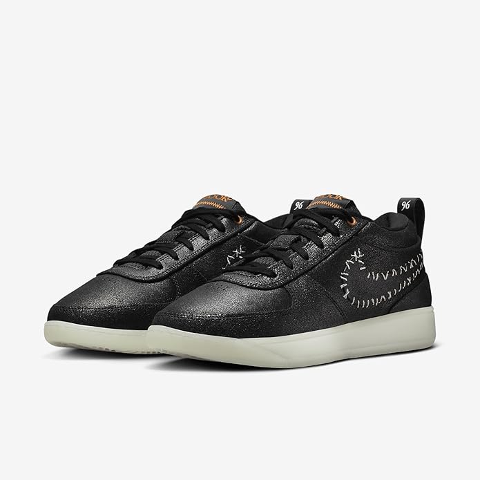 Pair of black Nike low-top sneakers with lace-up closure and stitched upper design