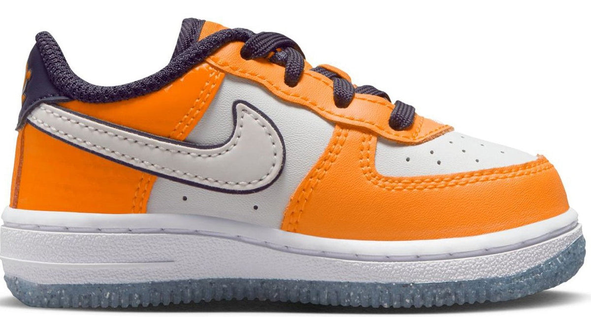 Orange and white low-top Nike sneakers with navy Swoosh and orange toe panel