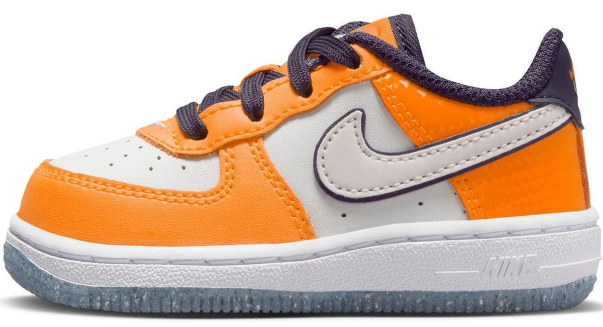 Orange and white low-top Nike sneakers with navy laces and Swoosh