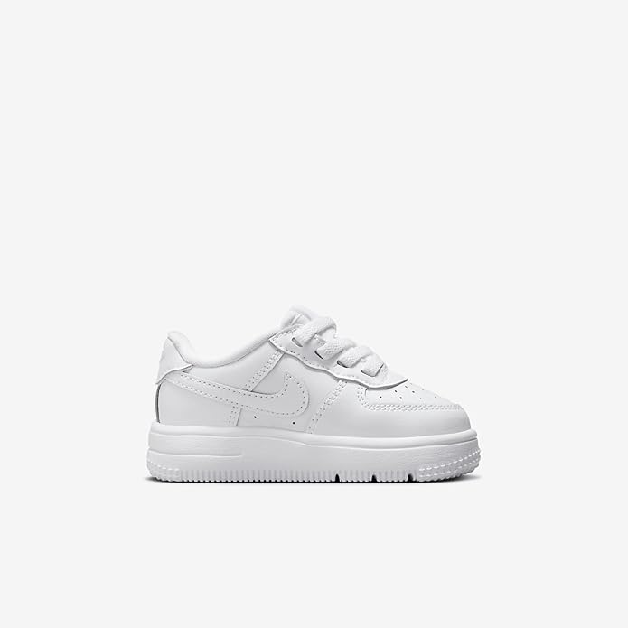 Toddler white low-top sneakers with stitched panels, lace-up front, and Nike swoosh
