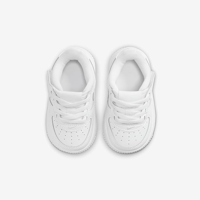 Pair of toddler white lace-up sneakers with padded collars and perforated toe panels