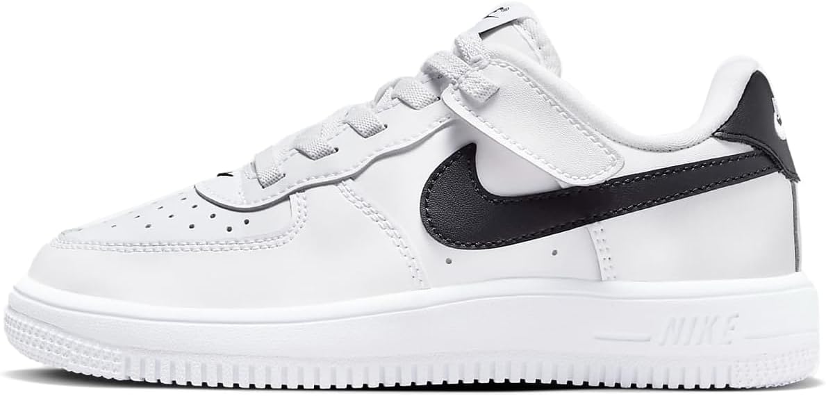 White low-top kids sneaker with black Nike Swoosh and lace-up front