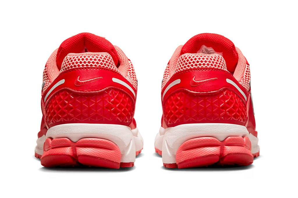 Red mesh running sneaker with white midsole and red heel, rear view