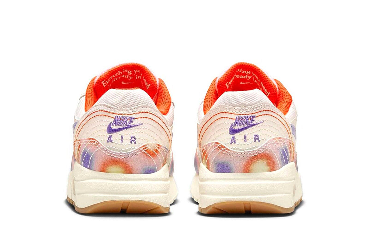Kids' Nike Air Max 1 heels with AIR branding and orange-lined collar