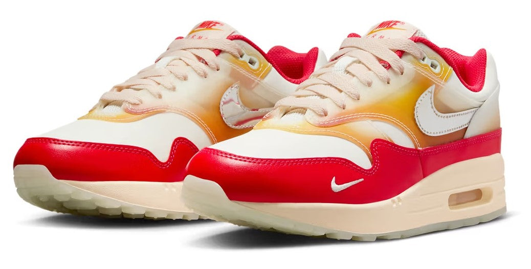 Women's Nike Air Max 1 PRM sneakers, front 3/4: cream laces, red panels, visible air window