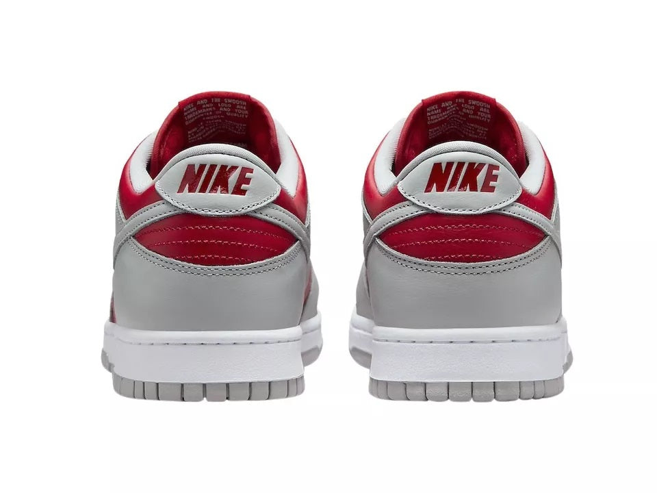 Nike Dunk Low sneakers, back view with white/gray leather and varsity red heel tab