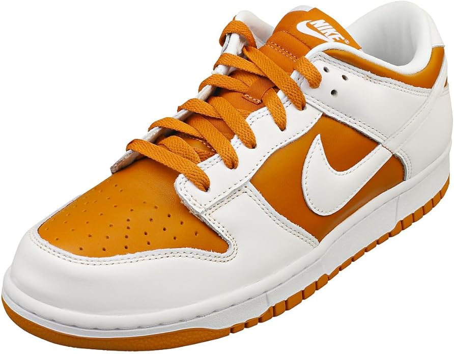 Low-top Nike Dunk sneakers, orange toe and laces with white overlays, gum rubber sole.