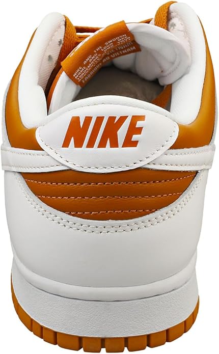 Back view of Nike Dunk sneakers with orange lining, white heel, and Nike logo strap.