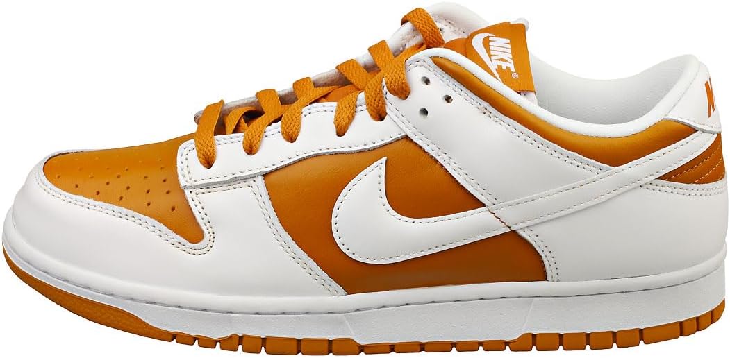 Low-top Nike Dunk sneakers with orange and white panels, orange laces and gum sole.