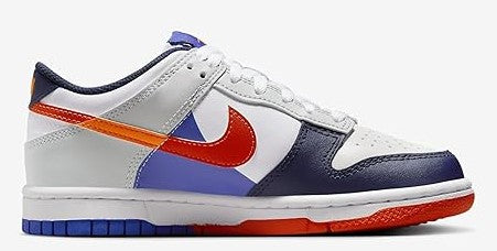 Kids low-top sneakers, white upper with navy toe and side panels, orange swoosh stripe