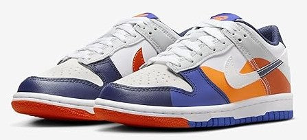 Pair of kids low-top sneakers, white leather with navy accents and orange swoosh details