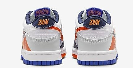 Kids low-top sneakers rear view, white leather with navy heel and blue outsole