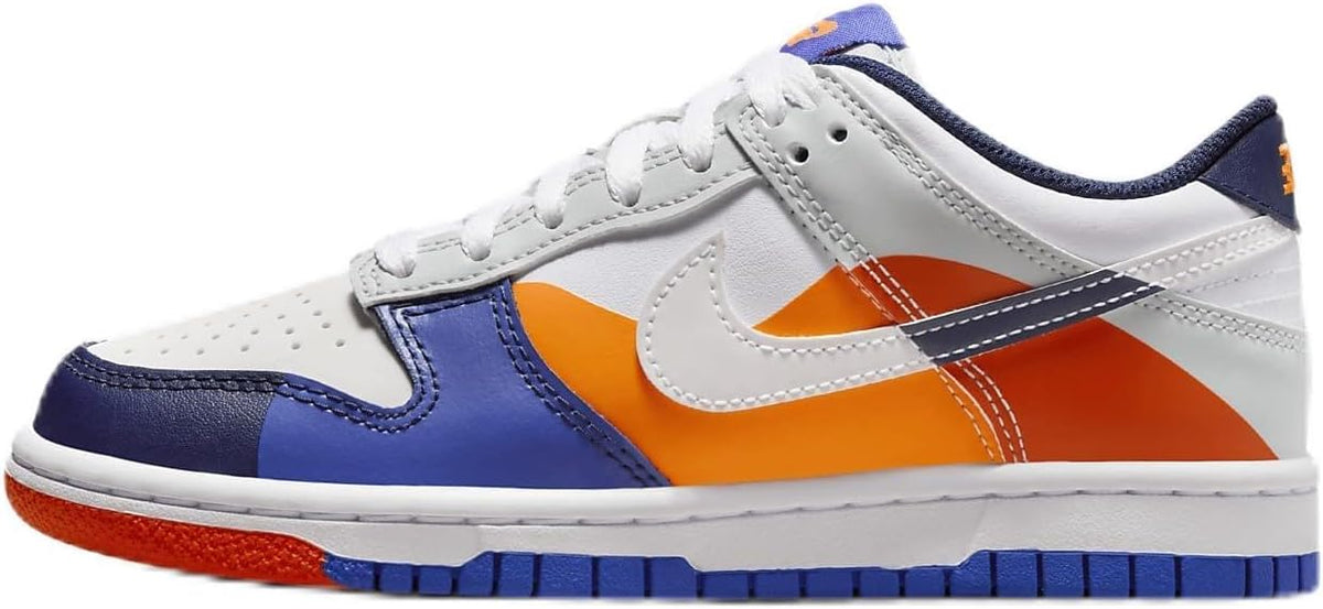 Kids low-top sneakers: white leather, navy overlays, orange swoosh, blue outsole