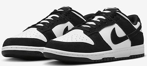 Pair of black and white Nike Dunk Low sneakers, angled view showing both shoes