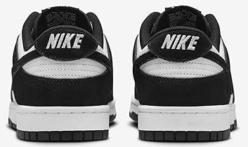 Black and white Nike Dunk Low sneakers, rear view with NIKE heel label