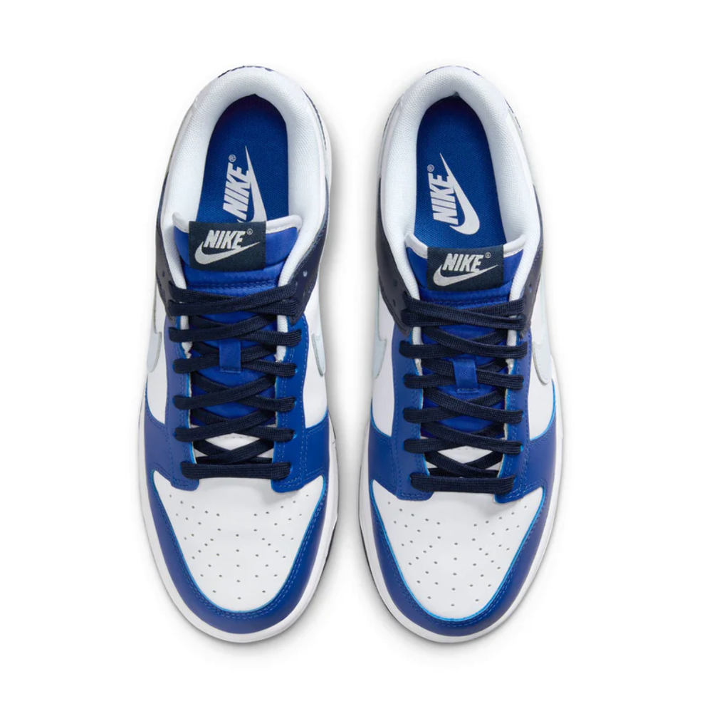 Pair of Nike Dunk Low sneakers with blue laces and white leather panels