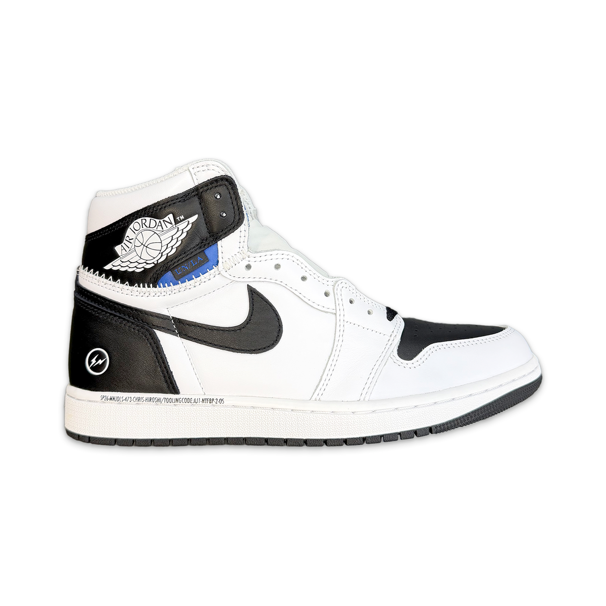 Air Jordan 1 Retro high-top sneaker in white with black overlays and blue accent on collar