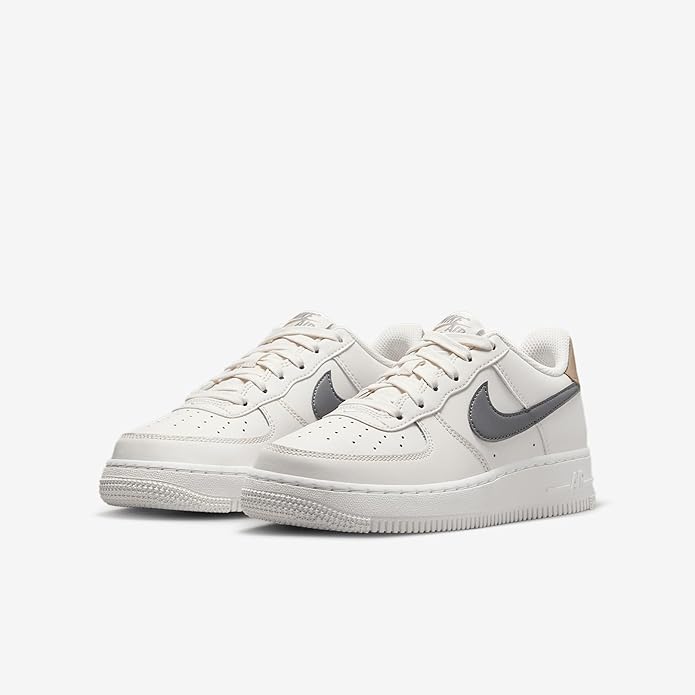 Kids' Nike Air Force 1 sneaker pair, white upper with gray swoosh and tan heel lining