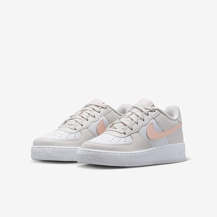 Big Kid's Nike Air Force 1 low sneakers, front pair view with pink heel accents