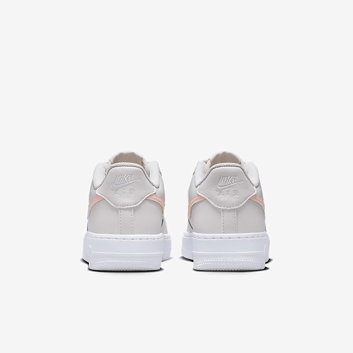 Big Kid's Nike Air Force 1 low sneakers, back view with pink trim on heel