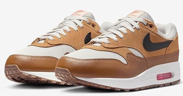 Pair of Nike Air Max 1 sneakers, light bone uppers with brown overlays and black swoosh