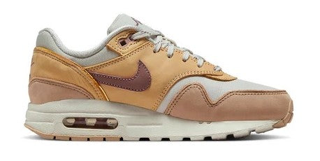 Kids' Nike sneakers with mauve swoosh, tan and peach uppers, light bone accents