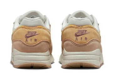 Kids' Nike sneakers with heel pull tabs, light bone lining and tan heel panels