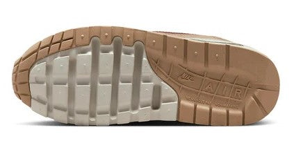 Kids' sneaker outsole with grippy tread and air unit window on light gray rubber