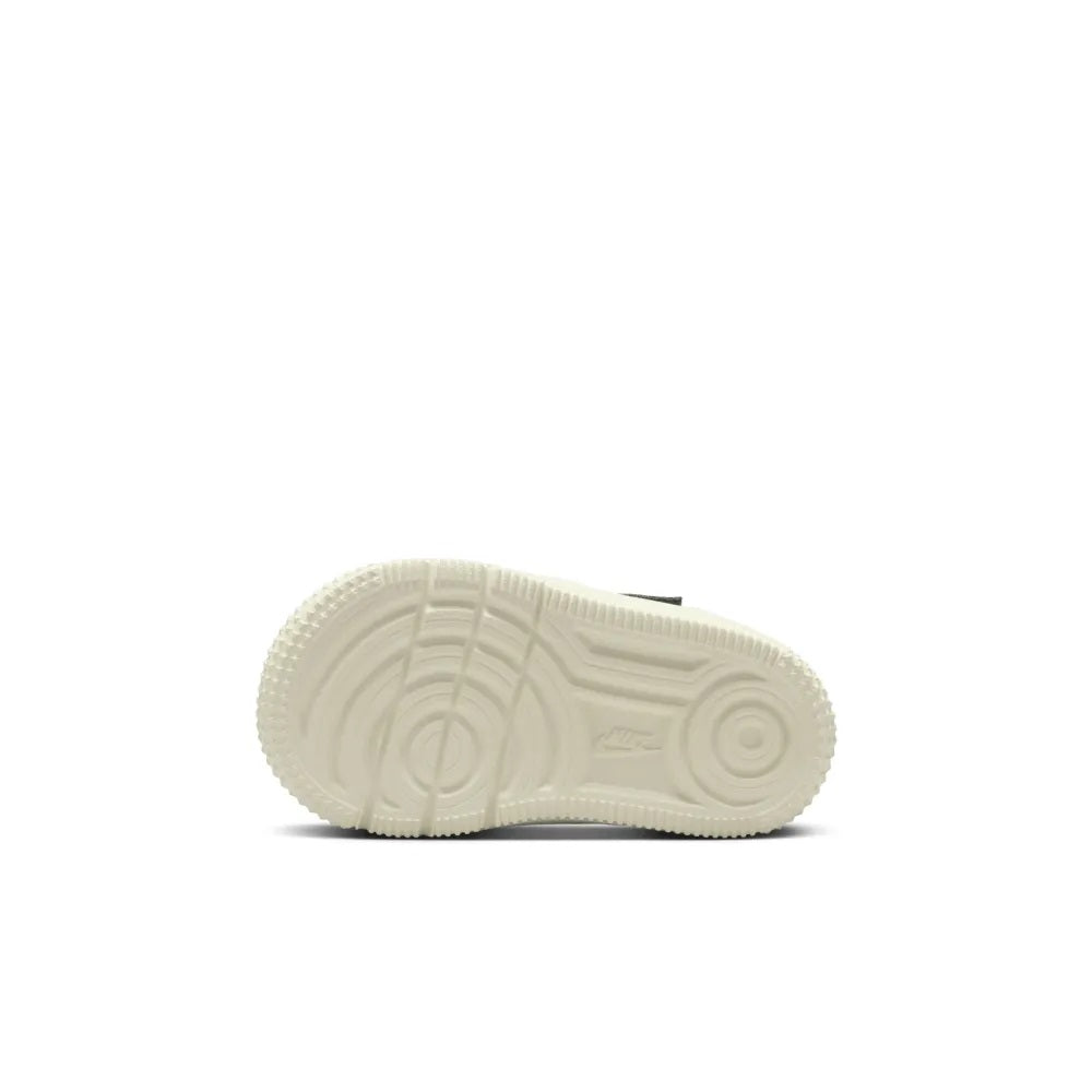 Toddler sneaker outsole with white rubber tread and circular traction grooves