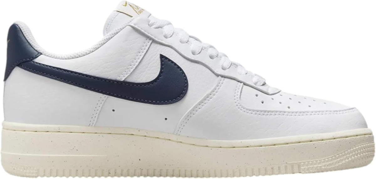 Nike Air Force 1 sneakers front-side view, white leather with navy swoosh, cream sole