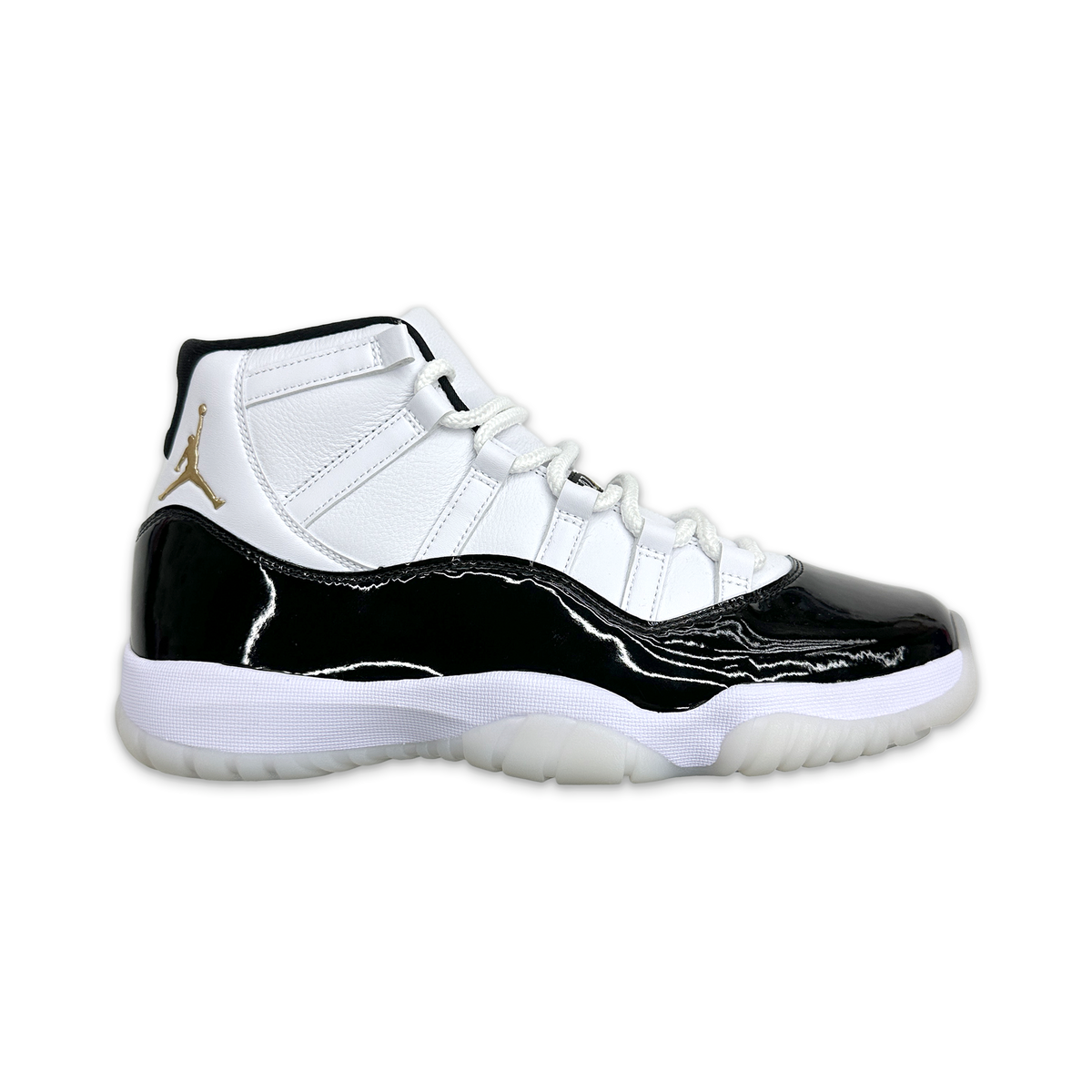 High-top Air Jordan 11 sneaker, white leather upper with black patent sides and gold logo