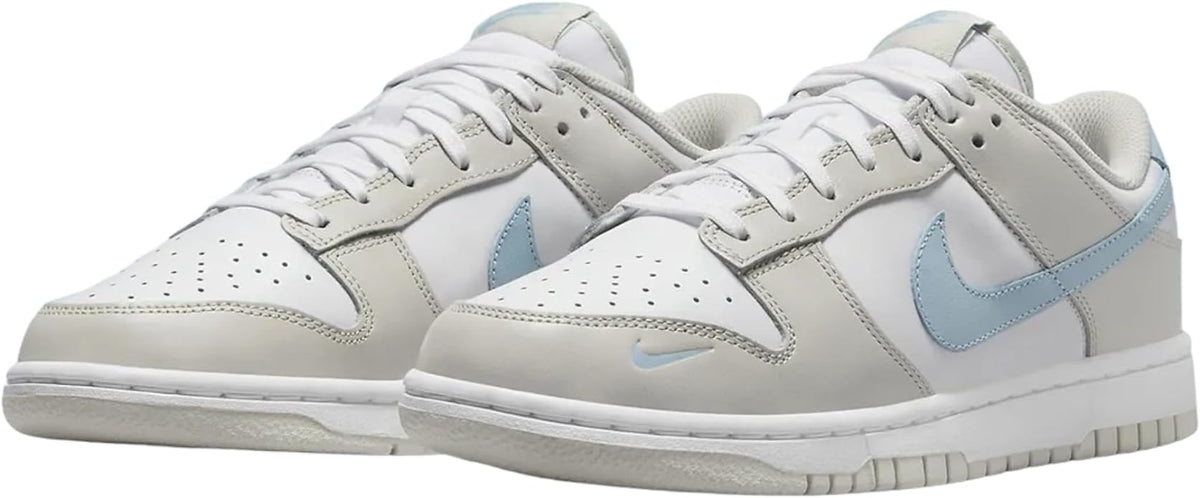 Pair of women’s Nike Dunk Low sneakers with white uppers and light blue Swoosh logos