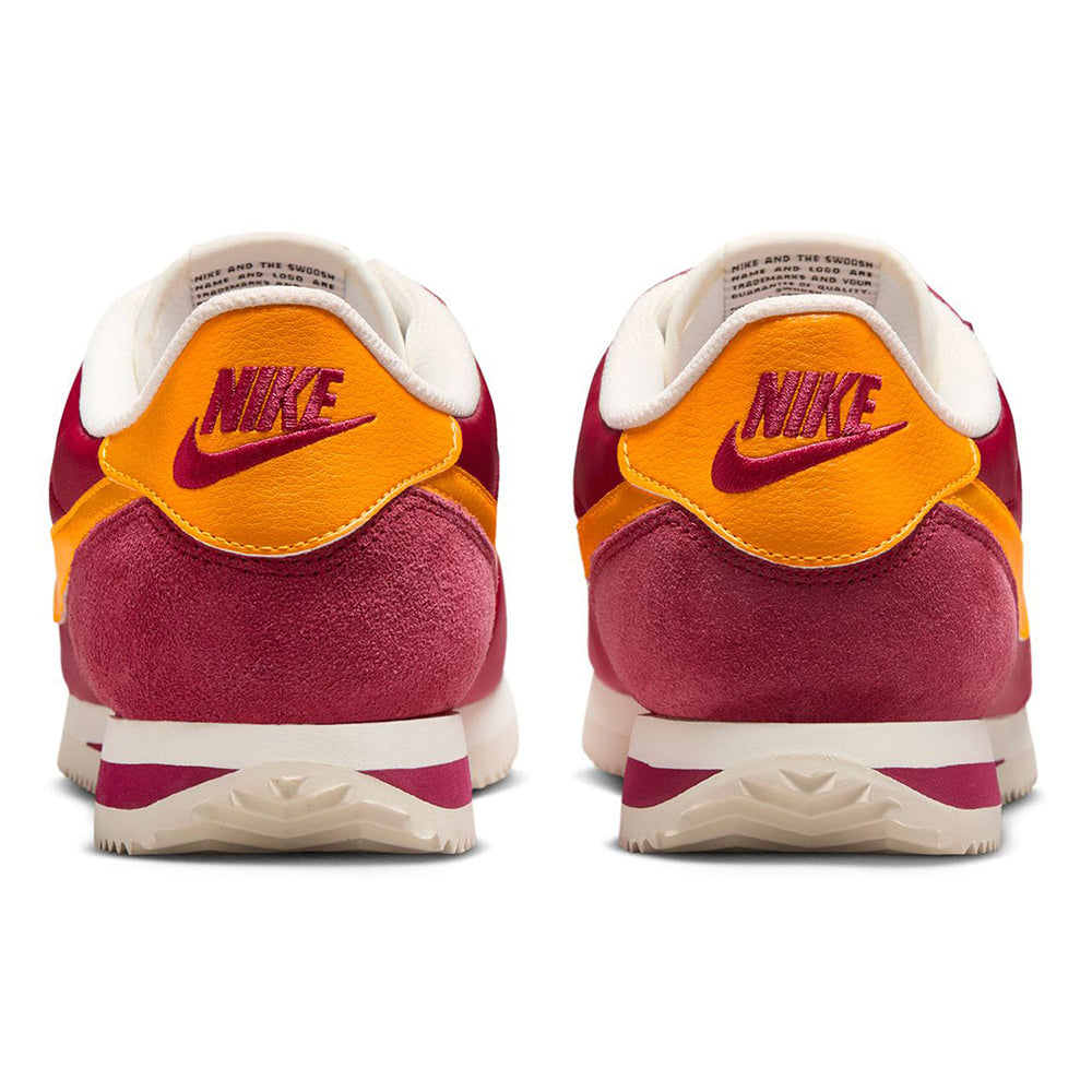 Men's Nike Cortez TXT sneakers with maroon heel, orange Nike logo, and cream midsole