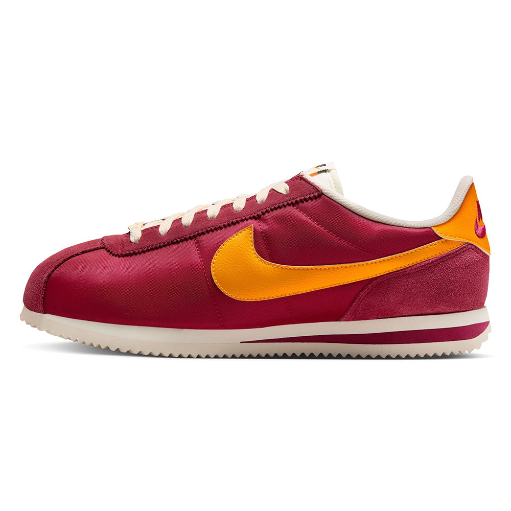 Men's Nike Cortez TXT side profile sneaker in maroon with yellow swoosh and white laces
