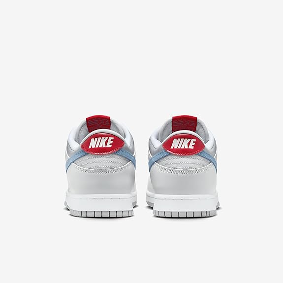 Nike Dunk Low QS sneakers, rear view with red Nike heel labels and light blue panels.