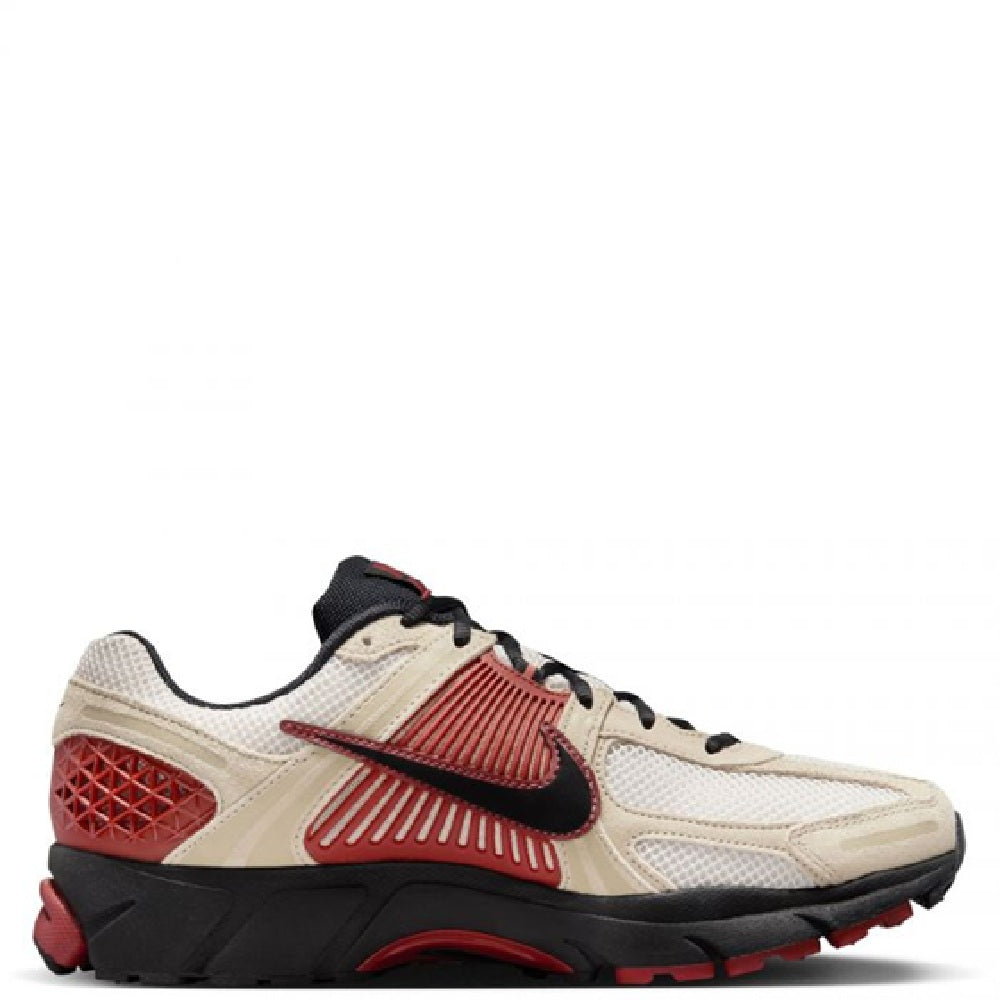 Nike Zoom Vomero 5 lace-up sneakers, light tan upper with red trim and black outsole