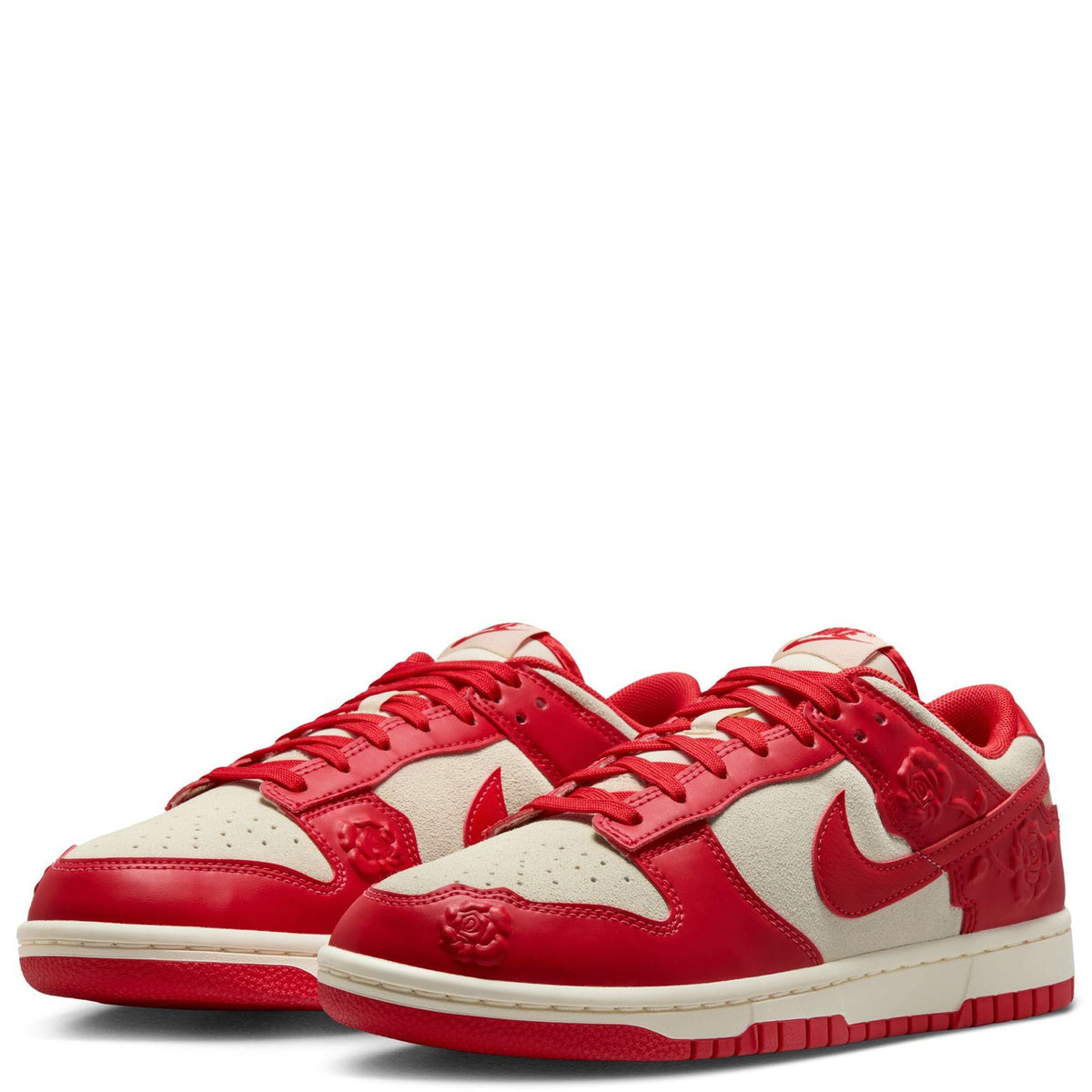 Nike Dunk Low sneakers pair view with red laces, cream panels and rose embossing