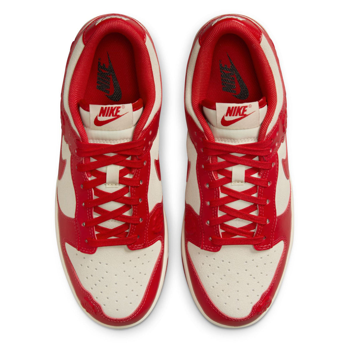 Nike Dunk Low sneakers with red laces and tongue, cream toe box and red panels