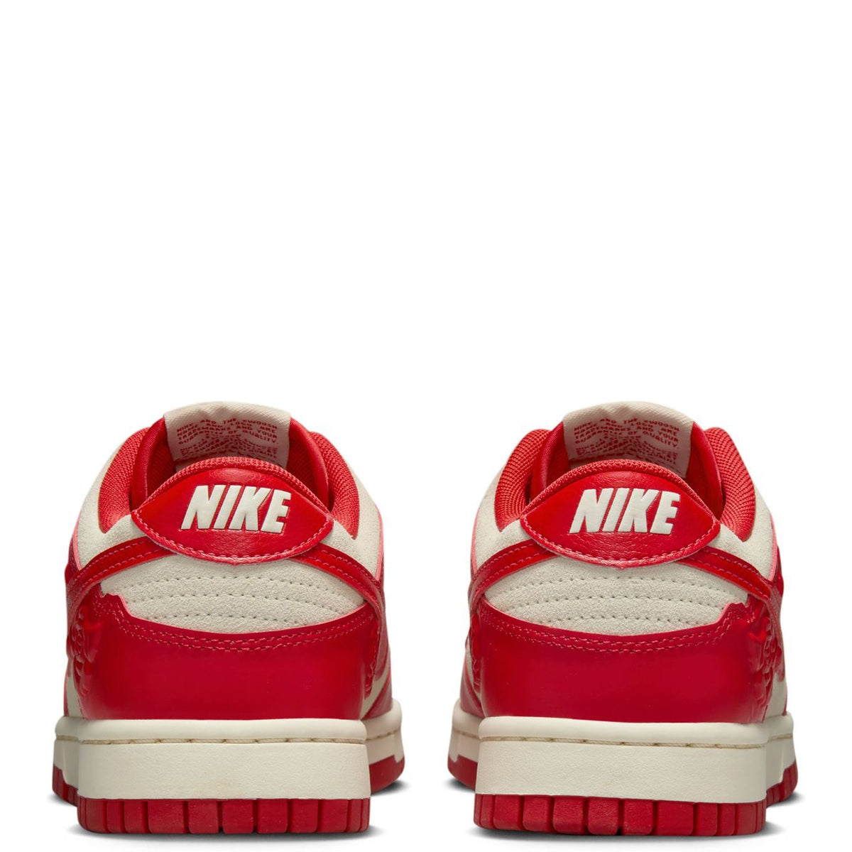 Nike Dunk Low sneakers heel view, red uppers with cream midsole and Nike logo