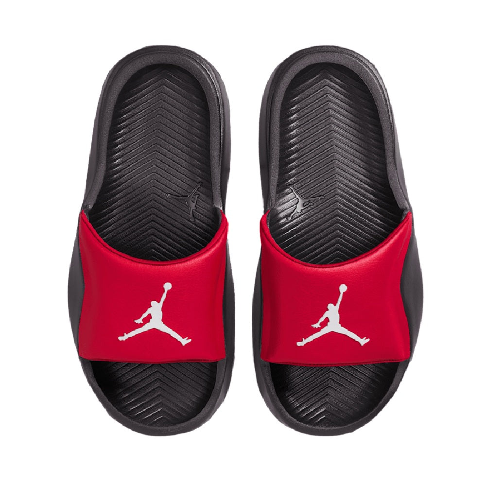 Pair of kids red slide sandals with white Jumpman logo and textured black footbeds
