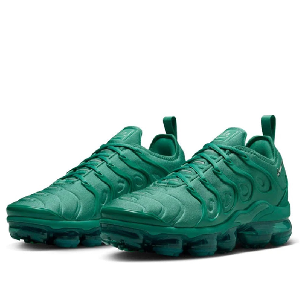 Pair of green Nike Air Vapormax Plus sneakers shown side-by-side, lace-up style and Max Air sole