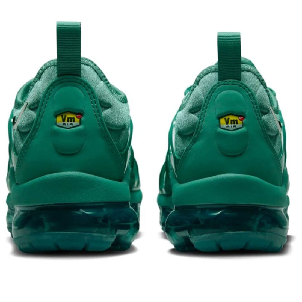 Green Nike Air Vapormax Plus sneakers, back view with heel tabs and Max Air bubble outsole