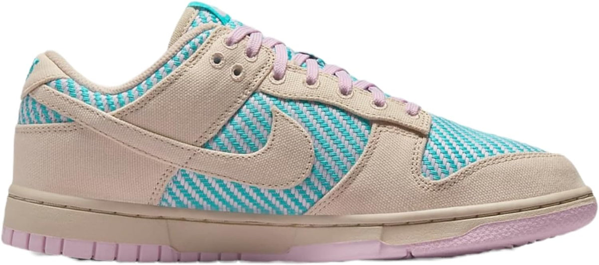 Women's Nike Dunk Low sneakers, sand canvas upper with teal swoosh and purple laces.