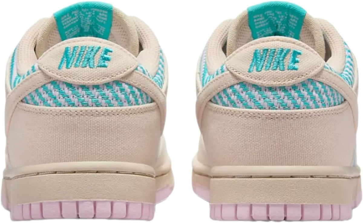Women's Nike Dunk Low sneakers with cushioned heel, sand back panels and teal Nike logo.