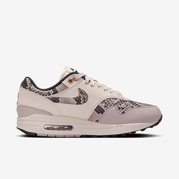 Light pink low-top sneakers with purple snake-print Swoosh and clear Air window